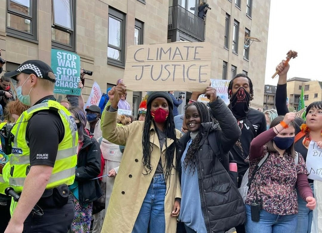 Vanessa Nakate holding a sign that says climate justice