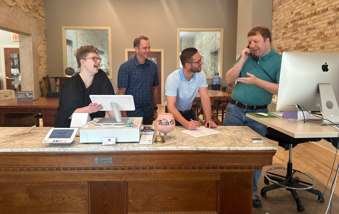 Swift Printing team collaborating at the front desk.