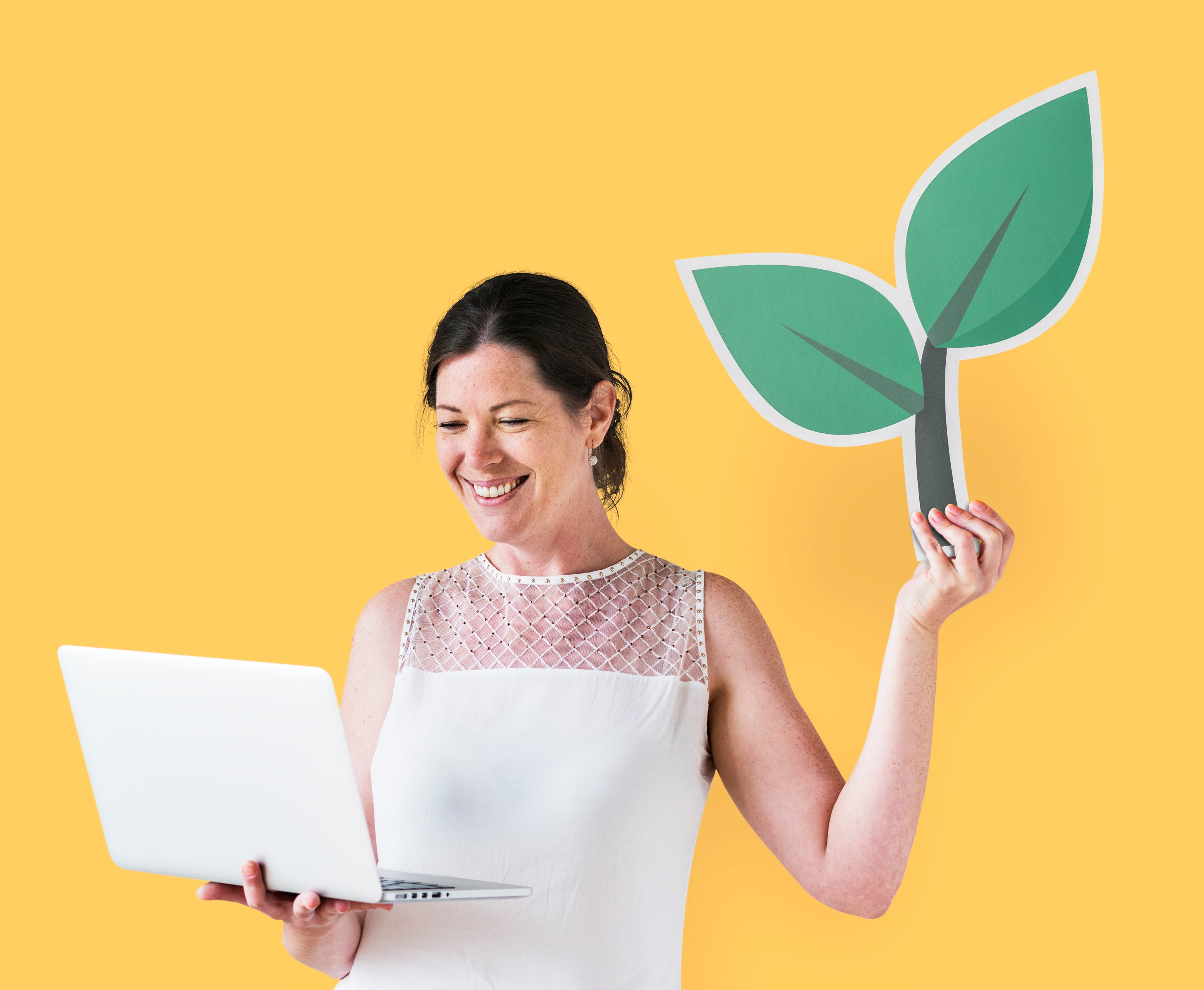 The image shows a lady working on a laptop and holding a green leaf indicating importance of cause marketing