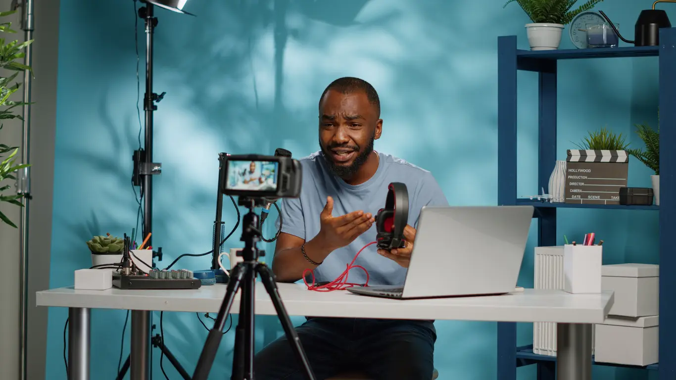 Content creator recording a video about mission-driven marketing with camera, laptop, and studio setup for digital storytelling