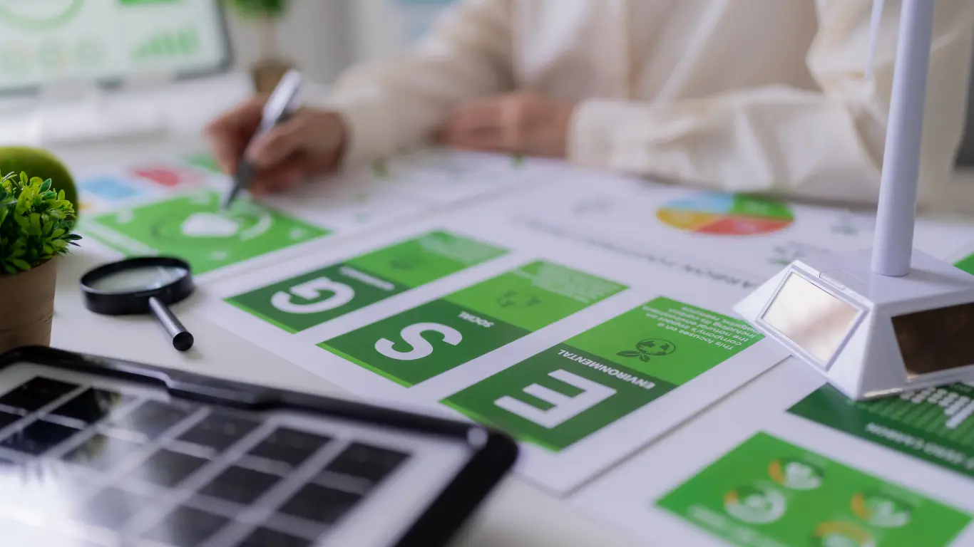 Business team analyzing purpose-driven marketing analytics and audience engagement data around a table