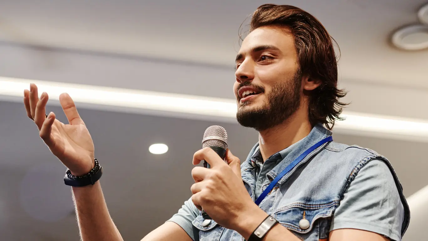 Founder speaking at an event about purpose-driven branding and authentic storytelling to engage a live audience