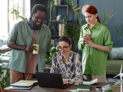 Sustainable digital marketing professionals developing purpose led campaigns in an eco conscious office setting